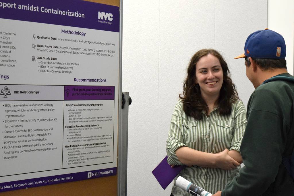 one student smiling to another student