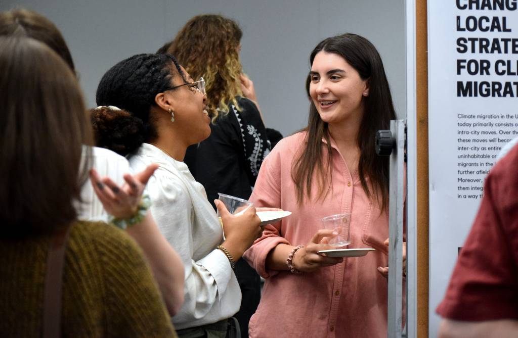 two students talking and smiling